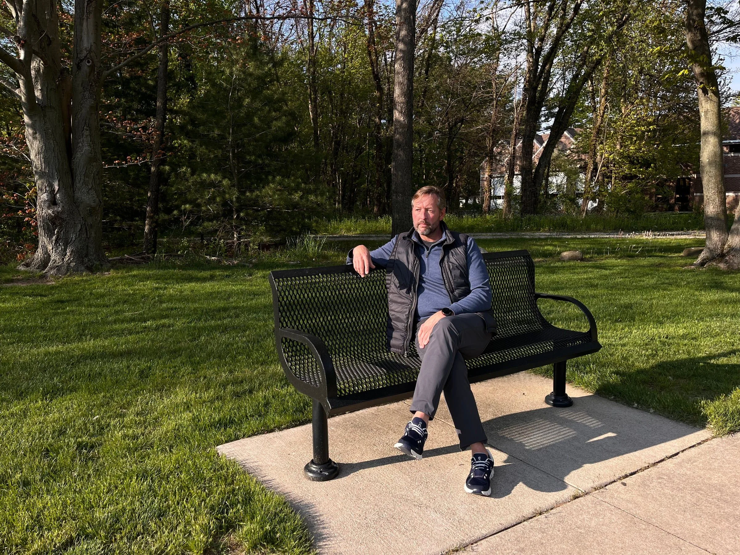 James Miller II seated on a park bench, May 2026